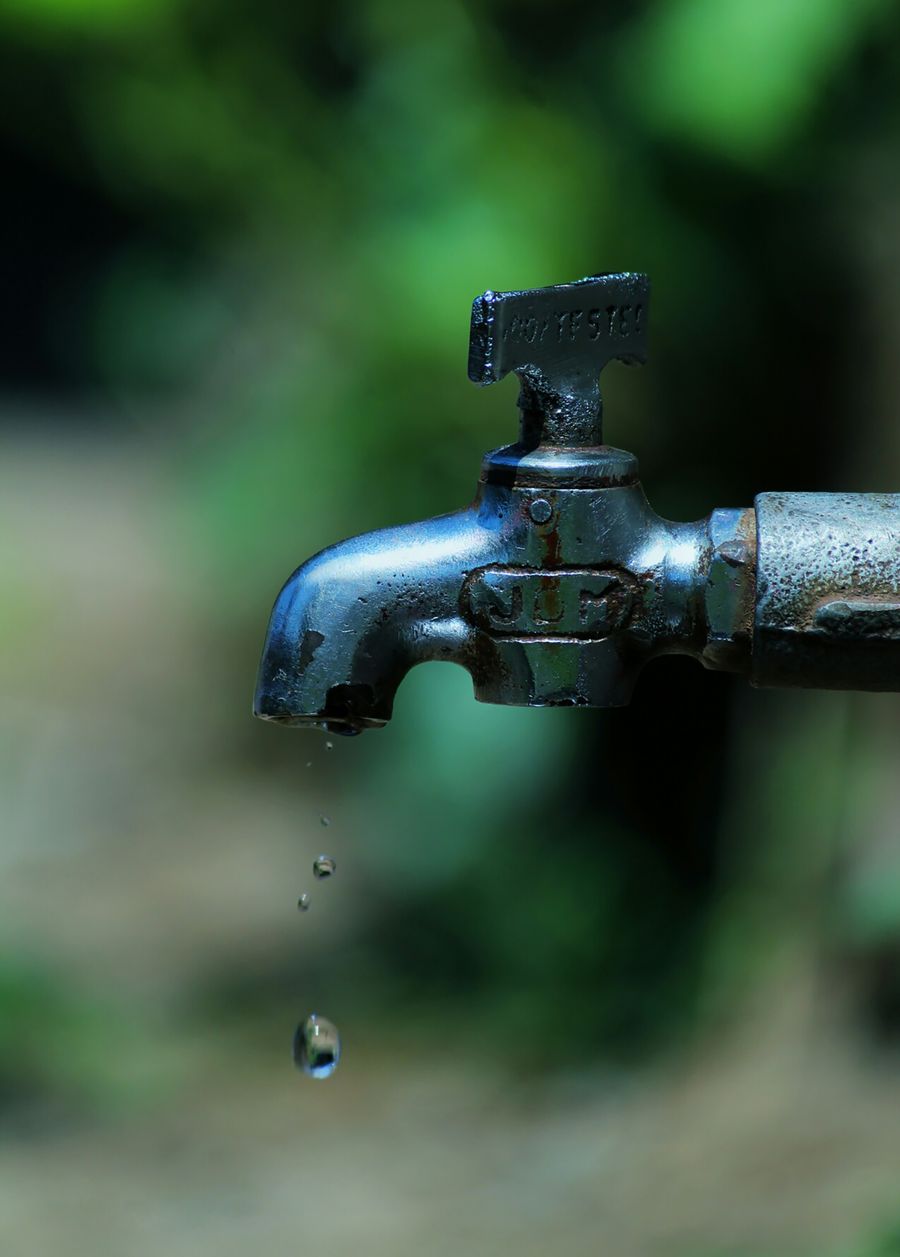 Old corroded faucet and supply lines with heavy mineral buildup before replacement
