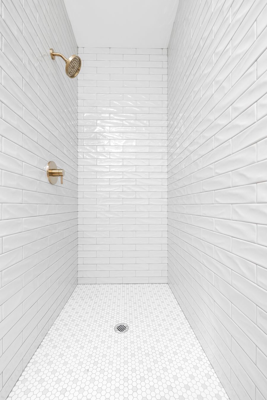 Custom tile shower with brass hardware — complete plumbing rough-in and fixtures